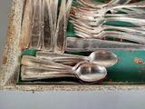 a lot of silver spoons and spoon spoons in a box