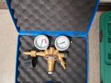 a blue case with two gauges inside of it