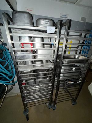 many pots and pans on the rack in the kitchen