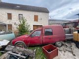 a red van that is parked in front of a building