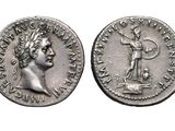 a silver coin with an image of a man holding a sword