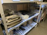 many trays and pans on the shelves in the kitchen