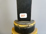 a black and yellow fire hydrant sitting on top of a table