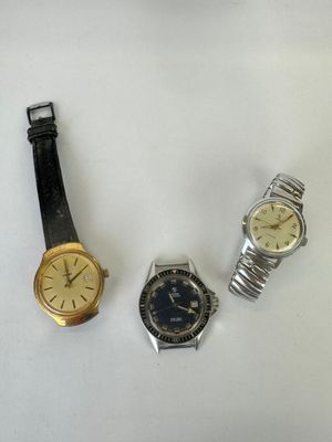three different types of watches are displayed on a white surface