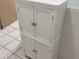 a bathroom with a sink and a cabinet in it