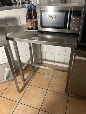 a microwave sitting on top of a table in a kitchen