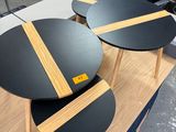 two black tables on a wooden table in a store