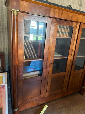a wooden cabinet with glass doors in a room