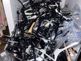 a pile of guns and other weapons in a room