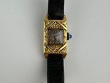 a watch that is sitting on a white surface
