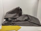 a gray cloth on the floor next to a yellow arrow