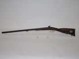 an old rifle with a wooden handle on a white background