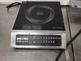 a black and silver stove top on a metal counter