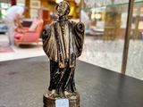 a statue of a man that is on a table
