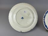 pair of blue and white porcelain plates with a blue and white design