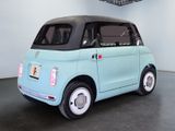 a small blue car with a black top in a room