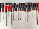 many different types of screwdrivers lined up on a wall