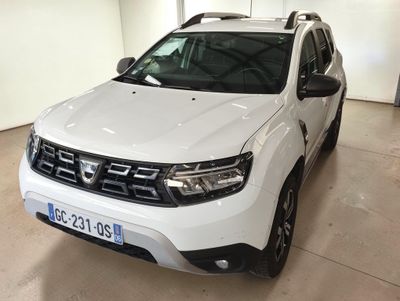 the front view of a white dacia parked in a garage