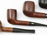 three different types of pipes on a white surface