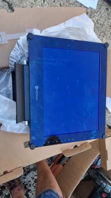 a blue laptop sitting on top of a cardboard box