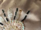 a picture of a brooch made out of buttons and beads