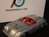 a silver toy car with a red seat in front of a box