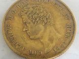 an old gold coin with a woman ' s head on it