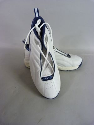 a pair of white and blue shoes on a table