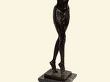 statue d'une femme aux bras tendus, posée sur un socle en marbre