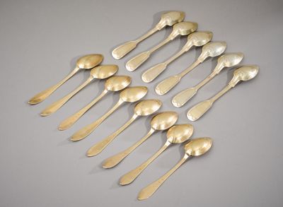 six silver spoons and two silver spoons on a table