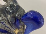 a blue glass vase with a gold decoration on it