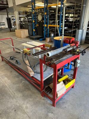 an industrial steel work bench in a large warehouse with lots of shelves