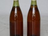 two bottles of wine sitting on a marble surface
