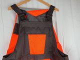an orange and black apron hanging on a hanger