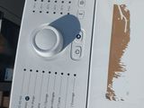 a white washing machine with a blue button on it