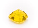 a yellow sapphire stone on a white background