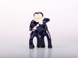 a small figurine of a man sitting on a chair