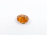 a close up of a yellow diamond on a white surface
