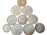 a close up of a pyramid of coins on a white surface