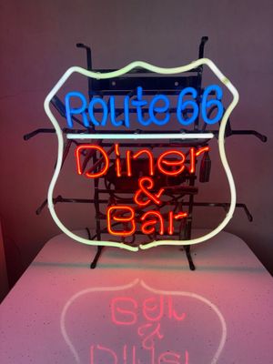 neon sign of route 66 diner and bar on a table