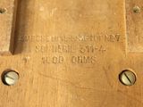 a close up of a piece of wood with some screws on it
