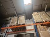many boxes on the pallets in the warehouse