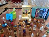 many bottles of perfume sitting on a table in a store