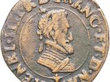Gros plan sur une pièce de monnaie portant le visage d'un homme