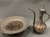 two pieces of silverware are sitting on a table next to each other