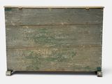 an old wooden chest with a green paint on it