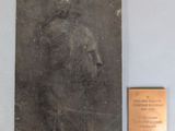 a plaque on the wall with a picture of a man ' s face