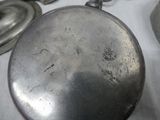 a silver pan sitting on a table with other silver pans