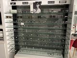 many glasses on display in a glass case in a store