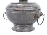 a silver metal container with a handle on it